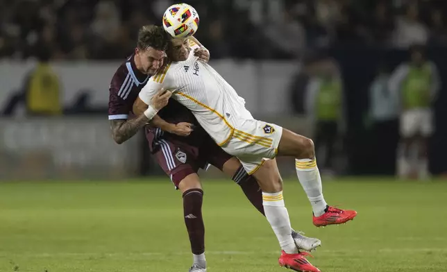 Los Angeles Galaxy forward Dejan Joveljić, right, and Colorado Rapids defender Andreas Maxsø battle for a header during the second half of the first match of an MLS Cup playoffs opening round, Saturday, Oct. 26, 2024, in Carson, Calif. (AP Photo/Kyusung Gong)