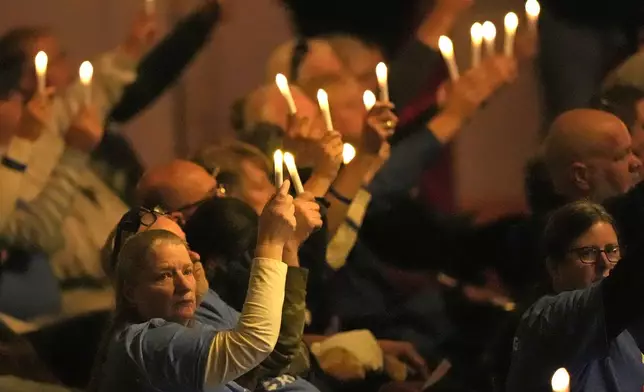 Attendees observe a moment of silence at a commemoration event to mark the one year anniversary of the mass shooting in Lewiston, Maine, Friday, Oct. 25, 2024. (AP Photo/Robert F. Bukaty)