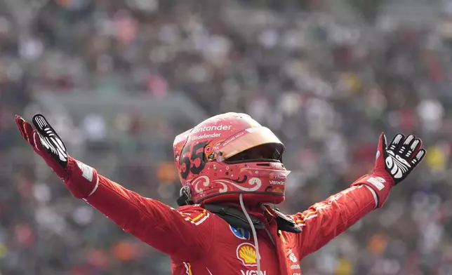 Ferrari driver Carlos Sainz of Spain celebrates after winning the Formula One Mexico Grand Prix auto race at the Hermanos Rodriguez racetrack in Mexico City, Sunday, Oct. 27, 2024. (AP Photo/Moises Castillo)