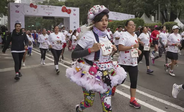 Fans of the Japanese character Hello Kitty compete in a race, during a celebration of the character's 50th anniversary, in Mexico City, Sunday, Oct. 13, 2024. (AP Photo/Aurea Del Rosario)