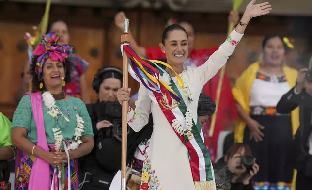 President Claudia Sheinbaum waves to supporters in the Zócalo, Mexico City's main square, during a rally on her inauguration day, Tuesday, Oct. 1, 2024. (AP Photo/Fernando Llano)