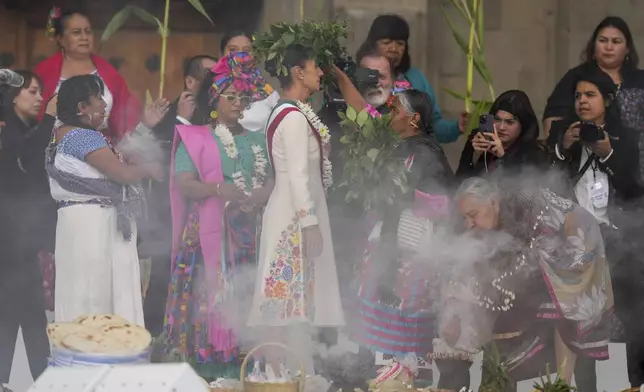 Indigenous women carry out a traditional ceremony for President Claudia Sheinbaum in the Zocalo, Mexico City's main square, on her inauguration day, Tuesday, Oct. 1, 2024. (AP Photo/Fernando Llano)