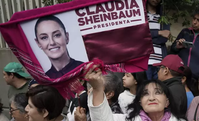 Supporters gather outside the house of Claudia Sheinbaum before she is sworn in as president in Mexico City, Tuesday, Oct. 1, 2024. (AP Photo/Aurea Del Rosario)