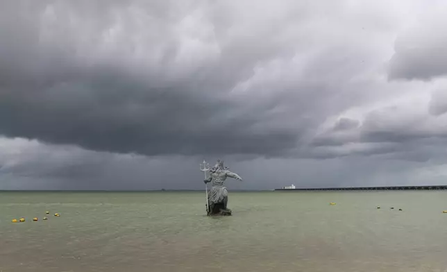 A sculpture of Poseidon stands in the ocean before the arrival of Hurricane Milton in Progreso, Yucatan state, Mexico, Monday, Oct. 7, 2024. (AP Photo/Martin Zetina)