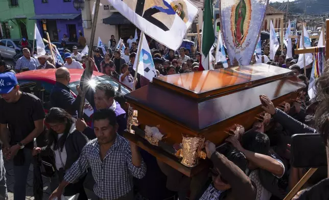 People carry the coffin of Catholic priest Marcelo Perez, who was killed in San Cristobal de las Casas, Chiapas state, Mexico, Sunday, Oct. 20, 2024. (AP Photo/Isabel Mateos)