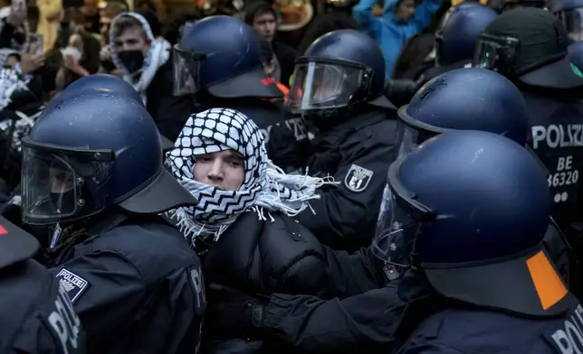 Police officers clash with protesters during a pro-Palestinian rally in Berlin, Germany, Sunday, Oct. 6, 2024. (AP Photo/Ebrahim Noroozi)