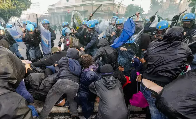 Italian Police and demonstrators clash during a march in support of the Palestinian people in Rome, Saturday, Oct. 5, 2024, two days before the anniversary of Hamas-led groups' attack in Israeli territory outside of Gaza on Oct. 7, 2023. (AP Photo/Andrew Medichini)