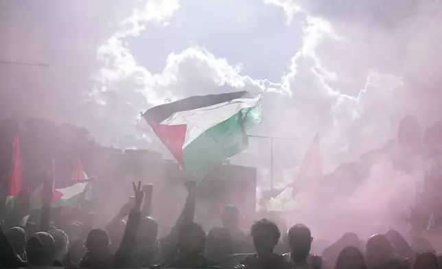 People attend at a protest in Rome, Saturday, Oct. 5, 2024. Pro-palestinians people take to the street in an unauthorised march in the centre of Rome two days ahead of the first anniversary of the Oct. 7. (AP Photo/Andrew Medichini)