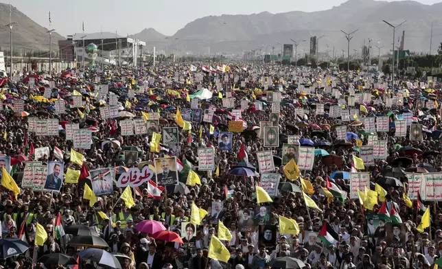 Thousands of Houthi supporters raise Hezbollah flags and posters of late leader Hassan Nasrallah during a rally to commemorate the one-year anniversary of the war in the Gaza Strip, in Sanaa, Yemen, Monday, Oct. 7, 2024. (AP Photo/Osamah Abdulrahman)