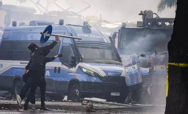 Italian Police and demonstrators clash during a march in support of the Palestinian people in Rome, Saturday, Oct. 5, 2024, two days before the anniversary of Hamas-led groups' attack in Israeli territory outside of Gaza on Oct. 7, 2023. (AP Photo/Andrew Medichini)