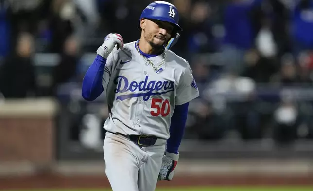 Los Angeles Dodgers' Mookie Betts celebrates after a two-run home run against the New York Mets during the sixth inning in Game 4 of a baseball NL Championship Series, Thursday, Oct. 17, 2024, in New York. (AP Photo/Ashley Landis)