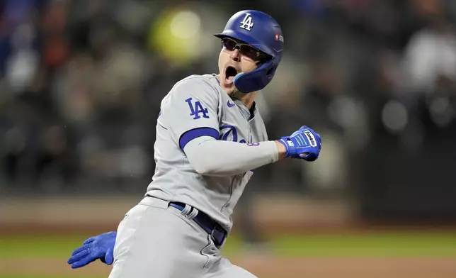 Los Angeles Dodgers' Enrique Hernández celebrates his two-run home run against the New York Mets during the sixth inning in Game 3 of a baseball NL Championship Series, Wednesday, Oct. 16, 2024, in New York. (AP Photo/Ashley Landis)