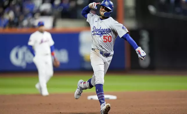 Los Angeles Dodgers' Mookie Betts celebrates after a two-run home run against the New York Mets during the sixth inning in Game 4 of a baseball NL Championship Series, Thursday, Oct. 17, 2024, in New York. (AP Photo/Frank Franklin II)