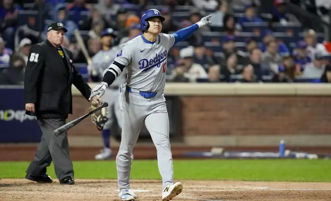 Los Angeles Dodgers' Shohei Ohtani celebrates his three-run home run against the New York Mets during the eighth inning in Game 3 of a baseball NL Championship Series, Wednesday, Oct. 16, 2024, in New York. (AP Photo/Ashley Landis)