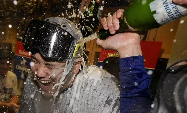 Los Angeles Dodgers Shohei Ohtani celebrates in the locker room after their win against the New York Mets in Game 6 of a baseball NL Championship Series, Sunday, Oct. 20, 2024, in Los Angeles. The Dodgers will face the New York Yankees in the World (AP Photo/Ashley Landis)