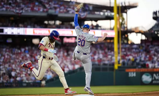 Philadelphia Phillies' Brandon Marsh is out at first as New York Mets first baseman Pete Alonso catches the throw from third baseman Mark Vientos during the seventh inning in Game 1 of baseball's National League Division Series, Saturday, Oct. 5, 2024, in Philadelphia. (AP Photo/Matt Slocum)