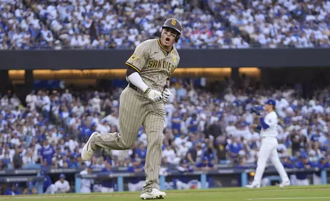 San Diego Padres' Manny Machado celebrates as he rounds first base after hitting a two-run home run during the first inning in Game 1 of baseball's National League Division Series against the Los Angeles Dodgers, Saturday, Oct. 5, 2024, in Los Angeles. (AP Photo/Mark J. Terrill)