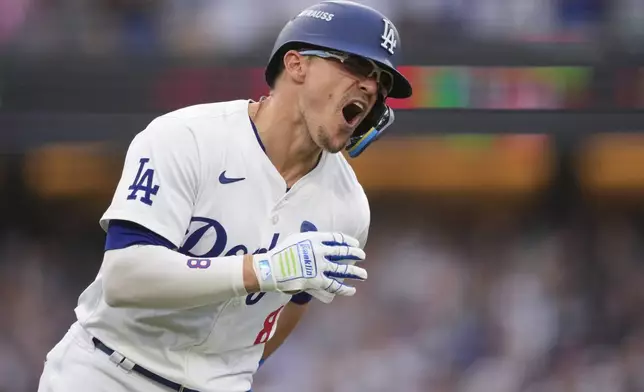 Los Angeles Dodgers' Kiké Hernández celebrates as he rounds first base following his solo home run during the second inning in Game 5 of a baseball NL Division Series against the San Diego Padres, Friday, Oct. 11, 2024, in Los Angeles. (AP Photo/Mark J. Terrill)