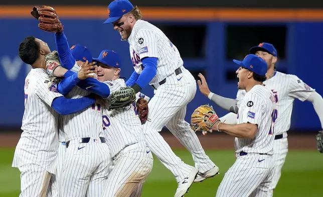 The New York Mets celebrate after defeating the Philadelphia Phillies in Game 4 of the National League baseball playoff series, Wednesday, Oct. 9, 2024, in New York. (AP Photo/Frank Franklin II)