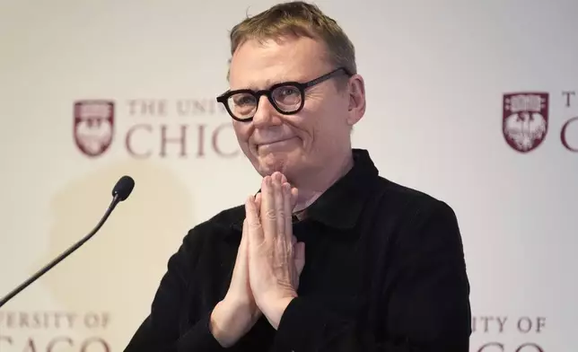 University of Chicago professor James A. Robinson, one of three winners of the 2024 Nobel Prize in Economics, responds to a standing ovation during a news conference celebrating Robinson at university Monday, Oct. 14, 2024, in Chicago. (AP Photo/Charles Rex Arbogast)