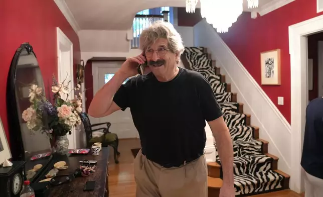 Gary Ruvkun, American molecular biologist, 2024 Nobel Prize winner in physiology or medicine, speaks on a phone, Monday, Oct. 7, 2024, at his home, in Newton, Mass. (AP Photo/Steven Senne)