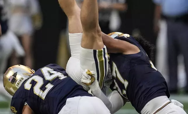 Georgia Tech wide receiver Bailey Stockton (87) is hit by Notre Dame linebacker Jack Kiser (24) during the second half of an NCAA college football game, Saturday, Oct. 19, 2024, in Atlanta. (AP Photo/Mike Stewart)