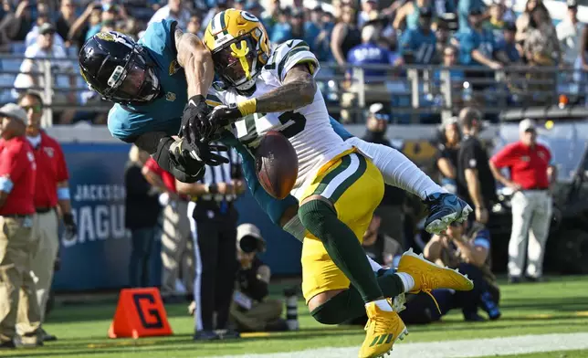 Green Bay Packers' Jaire Alexander breaks up a pass intended for Jacksonville Jaguars' Parker Washington during the second half of an NFL football game Sunday, Oct. 27, 2024, in Jacksonville, Fla. (AP Photo/Phelan M. Ebenhack)