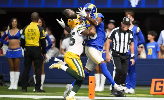 Green Bay Packers cornerback Keisean Nixon (25) breaks up a pass against Los Angeles Rams wide receiver Demarcus Robinson (15) during the first half of an NFL football game Sunday, Oct. 6, 2024, in Inglewood, Calif. (AP Photo/Gregory Bull)