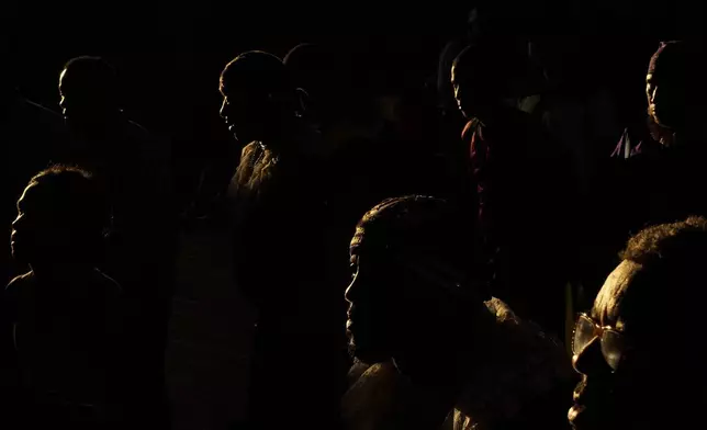 Pilgrims arrive inside San Felipe Church to honor the Black Christ in Portobelo, Panama, early Monday, Oct. 21, 2024, during a festival celebrating the iconic statue that was found on the shore in 1658. (AP Photo/Matias Delacroix)