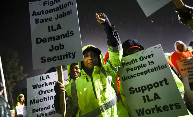 Dockworker Meikysha Wright and others strike outside the Virginia International Gateway in Portsmouth, Va., Tuesday, Oct. 1, 2024. (Billy Schuerman/The Virginian-Pilot via AP)