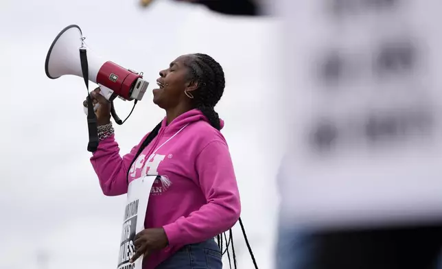 Striking longshoreman Teresa Whitte, of New York, pickets outside the Packer Avenue Marine Terminal Port, Tuesday, Oct. 1, 2024, in Philadelphia. (AP Photo/Matt Slocum)