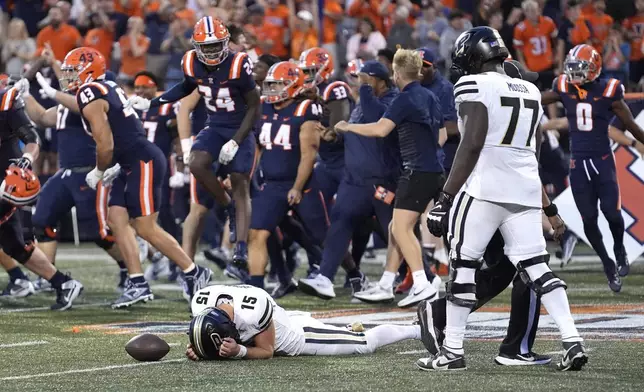 Purdue quarterback Ryan Browne lays on the ground after being sacked on a two-point conversion giving Illinois a 50-49 win in overtime during an NCAA college football game Saturday, Oct. 12, 2024, in Champaign, Ill. (AP Photo/Charles Rex Arbogast)