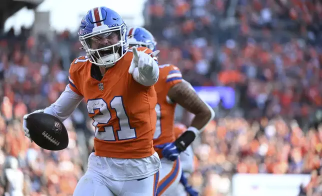 Denver Broncos cornerback Riley Moss (21) reacts after his interception intended for Las Vegas Raiders wide receiver Tre Tucker during the second half of an NFL football game, Sunday, Oct. 6, 2024, in Denver. (AP Photo/Geneva Heffernan)