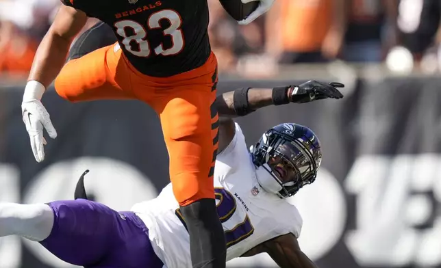 Cincinnati Bengals tight end Erick All Jr. (83) hurdles over Baltimore Ravens cornerback Brandon Stephens (21) during the second half of an NFL football game, Sunday, Oct. 6, 2024, in Cincinnati. (AP Photo/Carolyn Kaster)