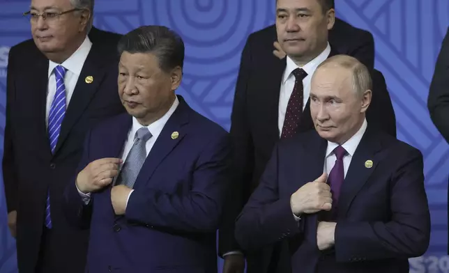 Chinese President Xi Jinping, left, and Russian President Vladimir Putin attend a family photo ceremony prior to Outreach/BRICS Plus format session at the BRICS Summit in Kazan, Russia, Thursday, Oct. 24, 2024. (Maxim Shipenkov, Pool Photo via AP)