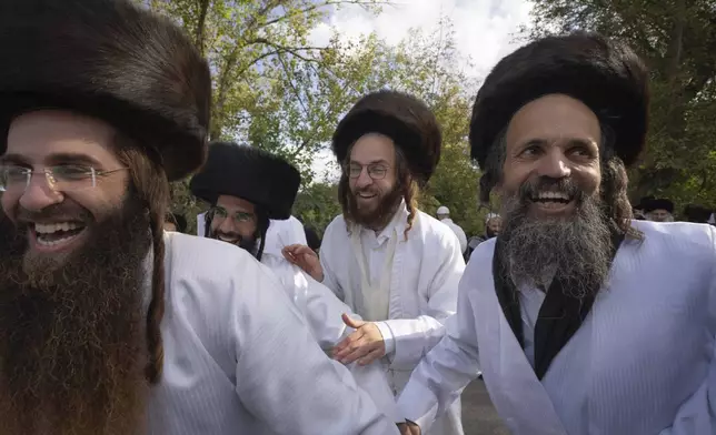 Orthodox Jews dance at the tomb of Rabbi Nachman, the great grandson of the founder of Hasidic movement, to mark the Jewish new year in the town of Uman, 200 kilometers (125 miles) south of Ukraine's capital Kyiv, Ukraine, Thursday, Oct. 3, 2024. (AP Photo/Efrem Lukatsky)