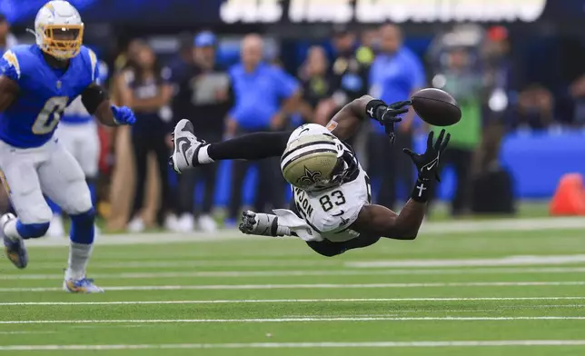 New Orleans Saints tight end Juwan Johnson (83) can't pull in a pass in the second half of an NFL football game against the Los Angeles Chargers in Inglewood, Calif., Sunday, Oct. 27, 2024. (AP Photo/Ryan Sun)