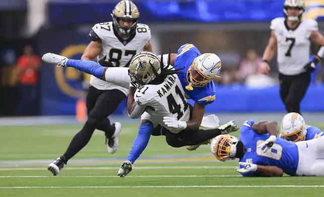 New Orleans Saints running back Alvin Kamara (41) is tackled by Los Angeles Chargers cornerback Tarheeb Still in the second half of an NFL football game in Inglewood, Calif., Sunday, Oct. 27, 2024. (AP Photo/Ryan Sun)