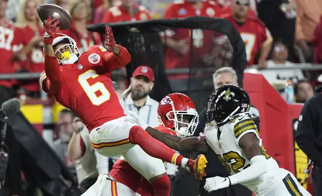 Kansas City Chiefs safety Bryan Cook (6) intercepts a pass intended for New Orleans Saints Rashid Shaheed, right, during the first half of an NFL football game Monday, Oct. 7, 2024, in Kansas City, Mo. (AP Photo/Charlie Riedel)