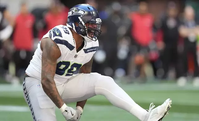 Seattle Seahawks defensive end Leonard Williams (99) reacts after sacking Atlanta Falcons quarterback Kirk Cousins during the first half of an NFL football game, Sunday, Oct. 20, 2024, in Atlanta. (AP Photo/ Brynn Anderson )