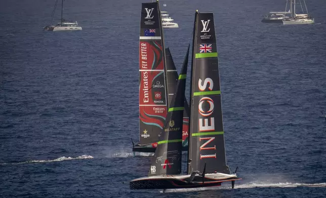 Ineos Britannia, right, and Emirates Team New Zealand race during the Louis Vuitton 37th America's Cup Day 4 race 5 in Barcelona, Spain, Wednesday, Oct. 16, 2024. (AP Photo/Emilio Morenatti)