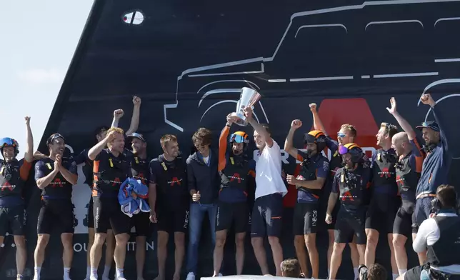 INEOS Britannia's team celebrate their victory against the Luna Rosa Prada Pirelli's sailing team during the Louis Vuitton Cup Final Day 7 at the Barcelona's coast, Spain, Friday, Oct. 4, 2024. (AP Photo/Joan Monfort)