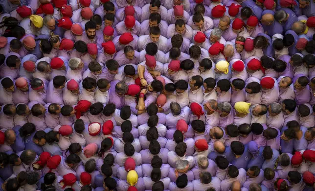 Members of "Colla Jove de Tarragona" form a "Castell" or human tower, during the 29th Human Tower Competition in Tarragona, Spain, Sunday, Oct. 6, 2024. (AP Photo/Emilio Morenatti)