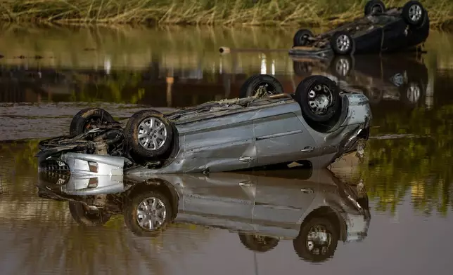 Flooded cars are piled up in Utiel, Spain, Wednesday, Oct. 30, 2024. (AP Photo/Manu Fernandez)