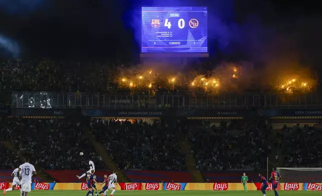 Supporters fire flares during the Champions League soccer match between Barcelona and Young Boys at the Lluis Companys Olympic Stadium in Barcelona, Spain, Tuesday, Oct. 1, 2024. (AP Photo/Joan Monfort)