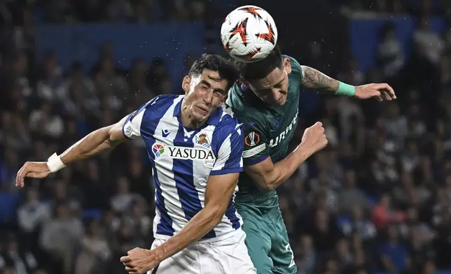 Real Sociedad's Nayef Aguerd, left, and Anderlecht's Luis Vazquez go for a header during the Europa League opening phase soccer match between Real Sociedad and Anderlecht at the Reale Arena in San Sebastian, Spain, Thursday, Oct. 3, 2024. (AP Photo/Miguel Oses)