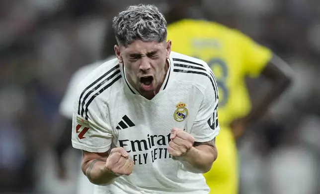 Real Madrid's Federico Valverde celebrates after he scored during the La Liga soccer match between Real Madrid and Villareal in Madrid, Spain, on Saturday, Oct. 5, 2024. (AP Photo/Bernat Armangue)