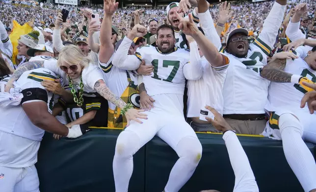 Green Bay Packers place kicker Brandon McManus (17) celebrates with fans after kicking the game-winning field goal in the second half of an NFL football game, Sunday, Oct. 20, 2024, in Green Bay, Wis. The Packers won 24-22. (AP Photo/Morry Gash)