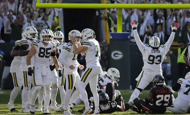 Green Bay Packers place kicker Brandon McManus (17) celebrates with teammates after kicking the game-winning field goal during the second half of an NFL football game against the Houston Texans, Sunday, Oct. 20, 2024, in Green Bay, Wis. The Packers won 24-22. (AP Photo/Mike Roemer)