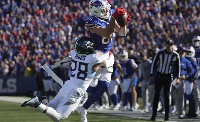 Buffalo Bills tight end Dalton Kincaid (86) makes a catch over Tennessee Titans safety Quandre Diggs (28) during the second half of an NFL football game Sunday, Oct. 20, 2024, in Orchard Park, N.Y. (AP Photo/Jeffrey T. Barnes)